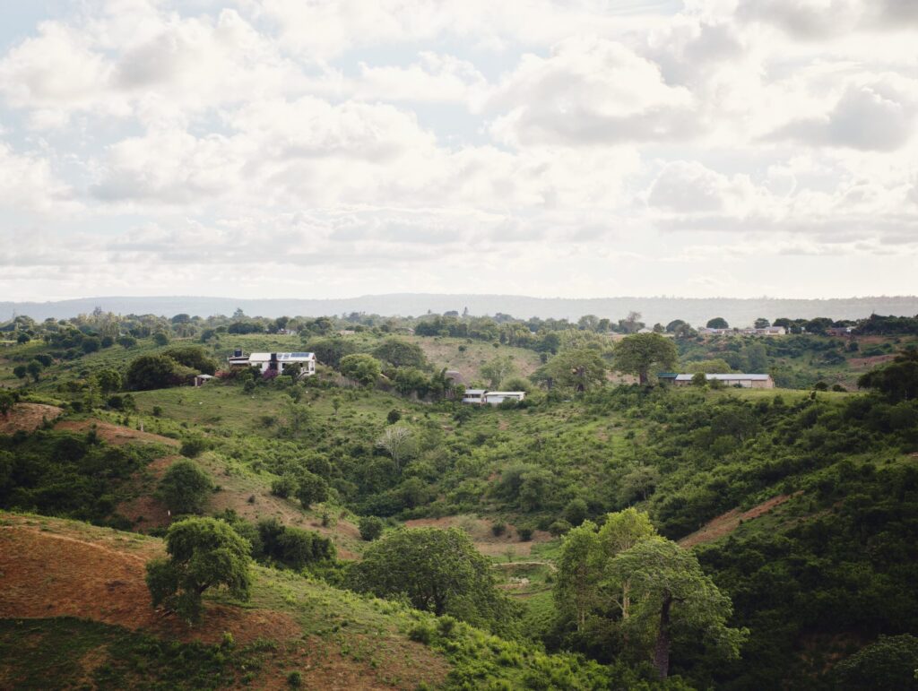 View across the green landscape around Neema Collective in Nzombere
